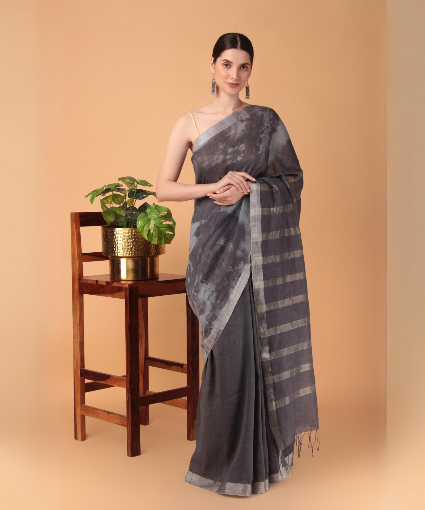 Handwoven linen saree crafted in tie n dyed blue colored base with silver zari border and striped aanchal