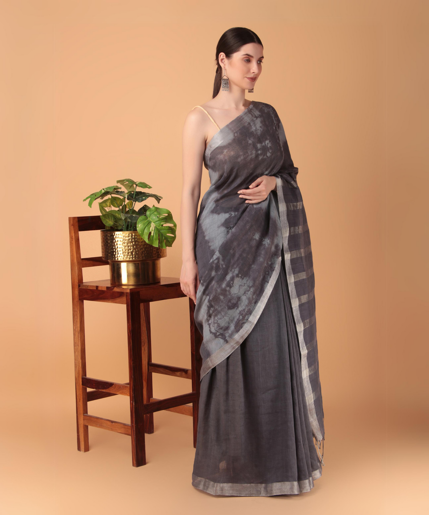 Handwoven linen saree crafted in tie n dyed blue colored base with silver zari border and striped aanchal