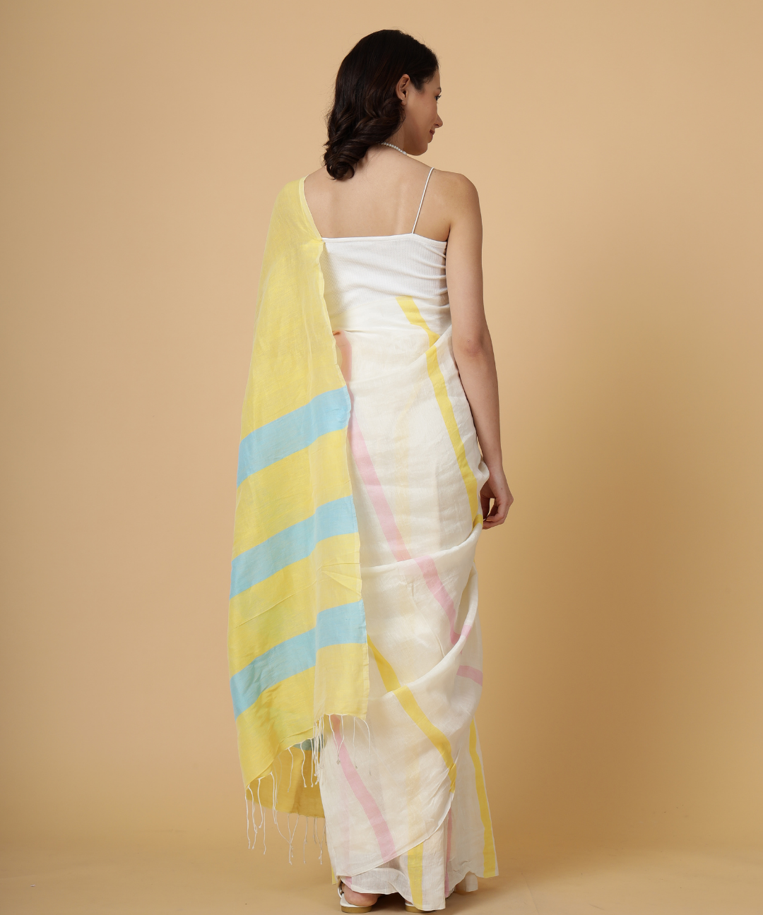 Handwoven linen saree crafted in cream colored base with stripes